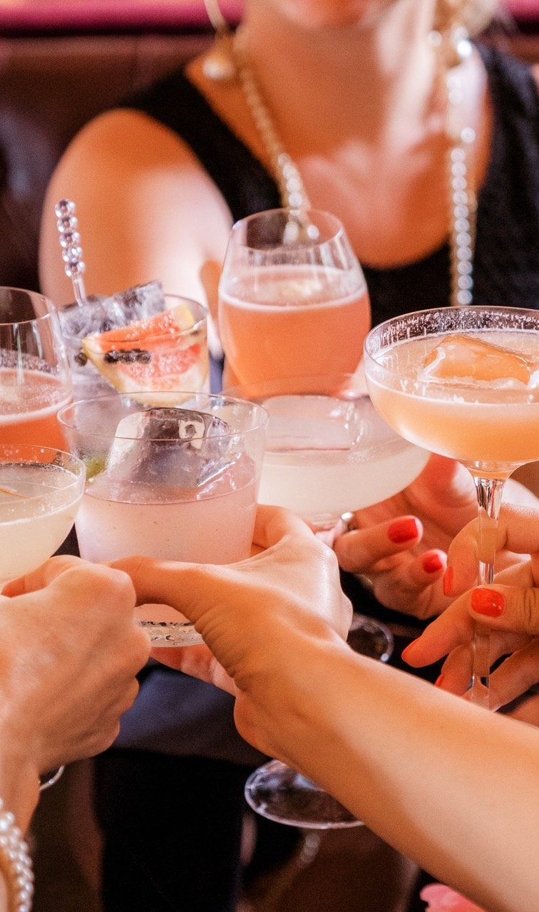 Guests raising cocktail glasses in a toast